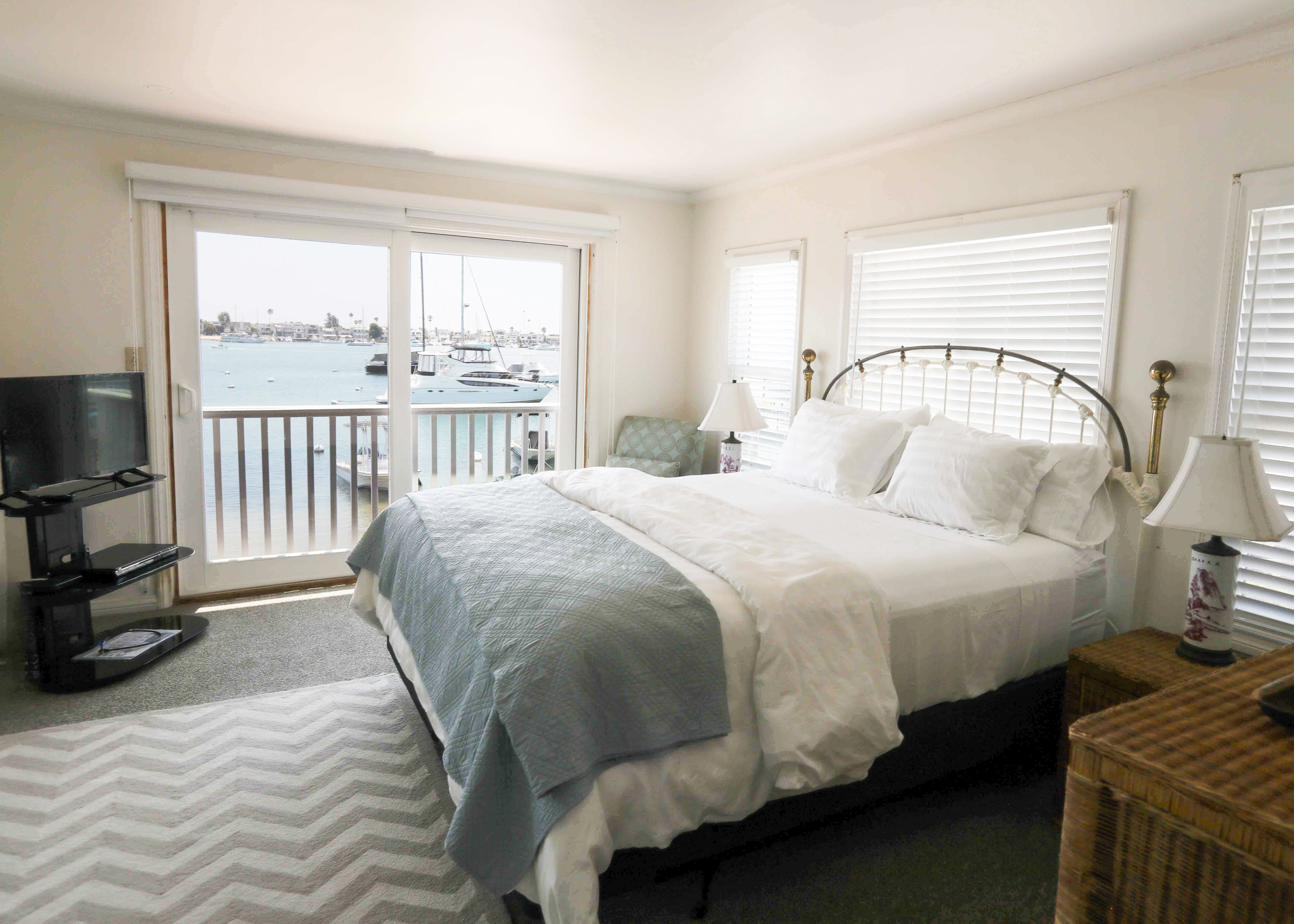 Master bedroom with a private balcony over the harbor